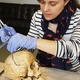 Dr. Sarah Inskip examines the skull of Context 958. (Image credit: Laure Bonner)